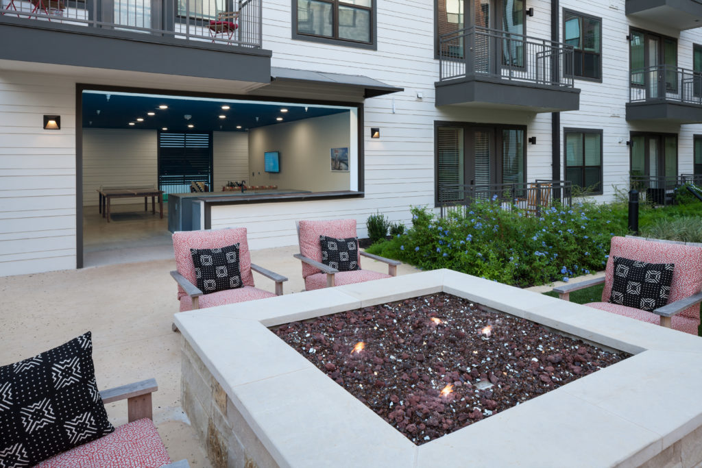 fire pit in the courtyard w/ seating at Alexan Garza Ranch - Picture an Ideal Weekend
